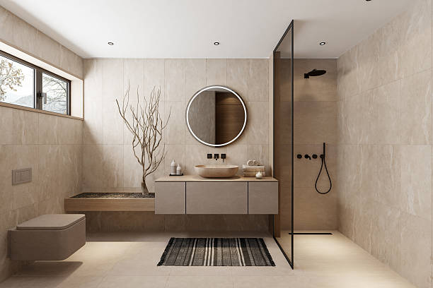 Modern Japandi style bathroom with natural beige stone tiles, floating vanity with round mirror, walk-in shower with black fixtures, and decorative wooden elements. Neutral colors, simple lines, and a mix of Japanese minimalism and Scandinavian coziness create a calm and elegant spa-like atmosphere. This image is ideal for illustrating concepts of interior design, bathroom renovation, modern home decor, wellness, relaxation, or architectural inspiration. bathroom remodeling buda TX