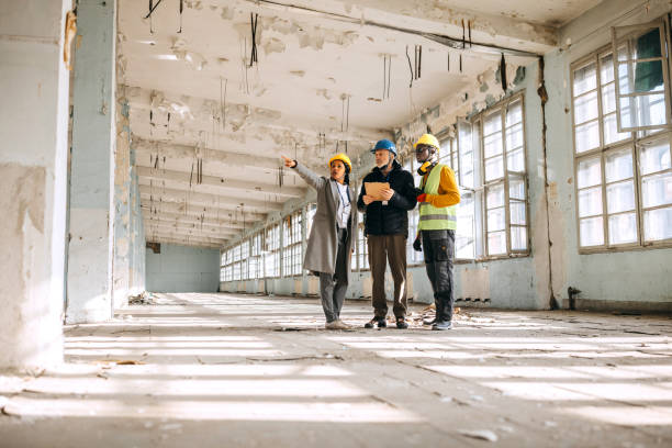 Architects looking at the architectural project and explaining to commercial remodeling contractors in austin TX what to do