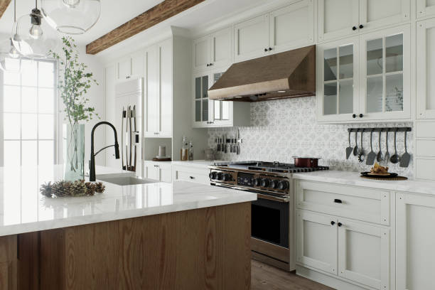 Traditional large L-shaped kitchen with large island and kitchen appliances. Kitchen interior with white cabinets and wooden island - all done by the best kitchen remodelers in San Marcos TX