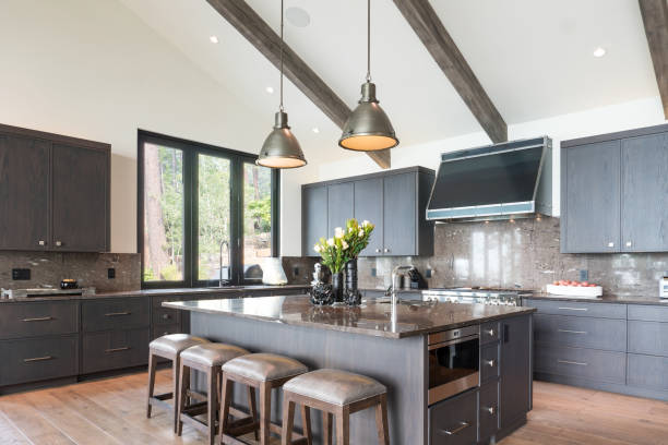 Kitchen island with four stools and two pendant lights above. Kitchen remodeling Lee County TX